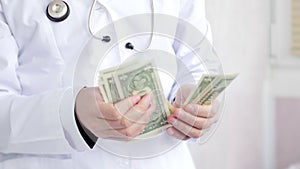 Corrupted doctor counting money and putting it into his pocket. UltraHD video