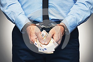 Corruption and bribery concept - arrested official with money