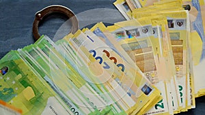 Corruption in the European Union.Handcuffs and falling euro bills on chalkboard background.Slow motion.Arrest on bank
