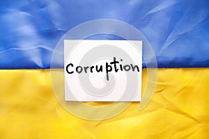 Corruption in Ukraine - text on Ukrainian flag, social issue concept