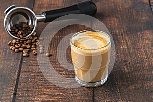 Cortado coffee with coffee beans next to it. Traditional coffee in Spain photo