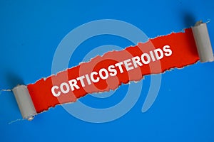 Corticosteroids Text written in torn paper