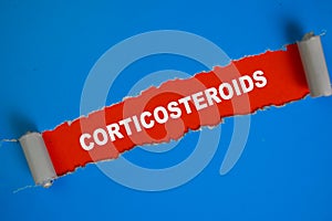 Corticosteroids Text written in torn paper photo
