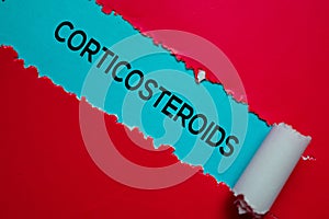 Corticosteroids Text written in torn paper. Medical concept photo