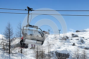 Cortina d`Ampezzo, February 2007: Skiers on the chairlift near Falzarego Pass. Veneto, Italy