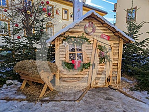 CORTINA D`AMPEZZO, ITALY - DECEMBER 29, 2022: View of pretty elf house in the main square of Cortina d`Ampezzo during christmas ti