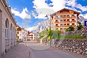 Cortina D` Ampezzo street and Alps peaks view photo