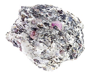 Corundum crystals in raw gneiss stone on white