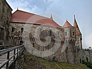 Corvin Castle in Hunedoara under cloudy sky