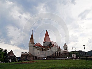 Corvin Castle in Hunedoara under cloudy sky