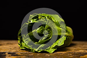Cos lettuce on wooden table photo