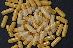 A close up of yellow supplement capsules photo