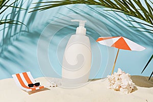 Cosmetic body care product for skin or hair, shampoo or gel, summer beach with paper accessories on blue background