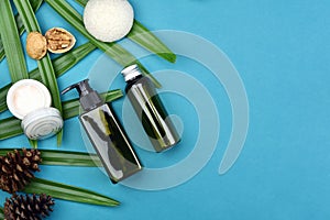 Cosmetic bottle containers on green herbal leaves background, Blank label for branding mock-up, Natural organic skincare.