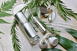 Cosmetic bottle containers packaging with green herbal leaves