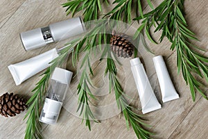 Cosmetic bottle containers packaging with green herbal leaves, Blank label for organic branding mock-up.