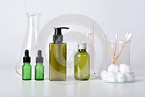 Cosmetic bottle containers and scientific glassware, Blank package for branding mock-up, Pharmaceutical skincare by dermatologist.