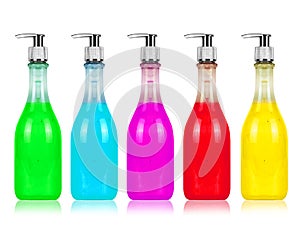 Cosmetic bottle in multi-colored versions isolated on white