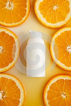 Cosmetic bottle with natural energy vitamin skin care. Cosmetic serum on an orange background