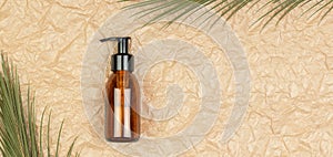 Cosmetic bottle with pump on crumpled beige paper background. Body care