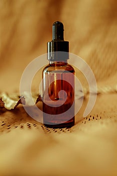 Cosmetic Bottle serum dark glass, oil cosmetic on beige paper background, flat lay, top view, copy space. minimalism
