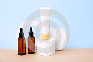Cosmetic bottles on the geometric podiums. Presentation template for natural beauty products on beige background