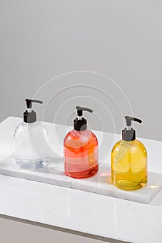 Cosmetic bottles with shower gel, body lotion or shampoo and bath towels. Bathroom accessories