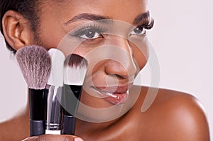 Cosmetic brushes, makeup and black woman with smile on face in studio and beauty application tool. Skincare, blush and