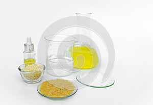 Cosmetic chemicals ingredient on white laboratory table. Carnauba Wax Flakes, Candelilla Wax, Microcrystalline wax, Nickle photo