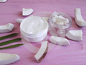 Cosmetic coconut cream on a pink wooden background