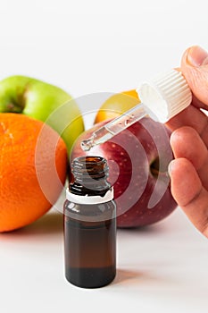 cosmetic concept, glass bottle with serum with alpha hydroxy acids on a background of fruit