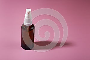 Cosmetic container with cosmetic product on a pink background