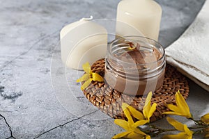 Cosmetic containers with cream and lotion and spring flowers