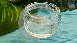 Cosmetic cream capsules falling pharmaceuticals on a wooden coconut treatment treatment slow-motion shot