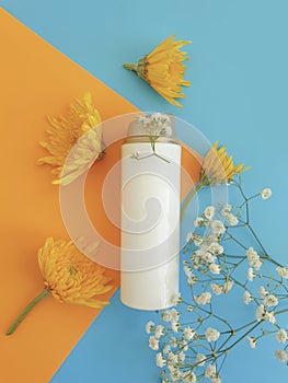 Cosmetic cream, flower  a colored background