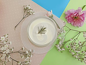 Cosmetic cream, flower on a colored background moisturizer