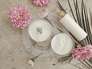 Cosmetic cream, flower natural lotion  therapy  organic wellness on a concrete background