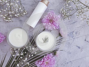 Cosmetic cream, flower natural organic wellness on a concrete background
