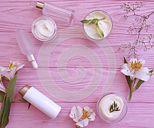 Cosmetic cream, flower product  design  natural on a wooden background wellness