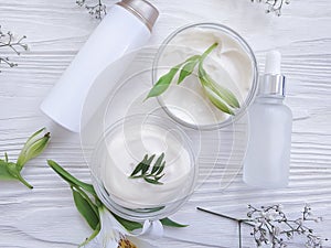 Cosmetic cream, flower product  on a wooden background wellness