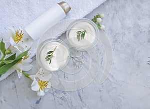 Cosmetic cream, flower protection    on  concrete background