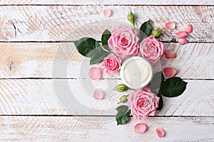 cosmetic cream and flowers on a colored background close-up.