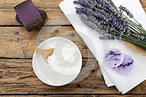 Cosmetic cream and lavender flowers