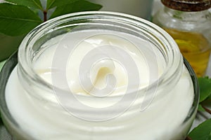 Cosmetic cream in open glass jar. Macro image
