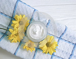 Cosmetic cream organic morning skincare yellow chrysanthemum flower white wooden, daisy, towel