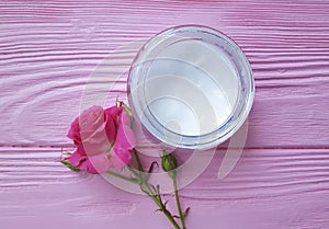 Cosmetic cream organic, roses, pink wooden table