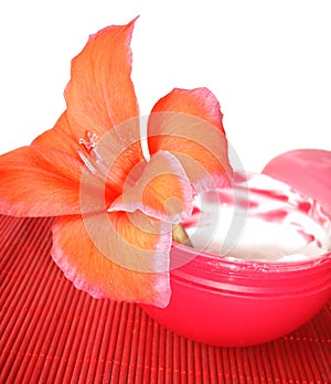 Cosmetic cream with red flower