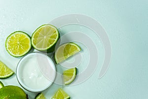 Cosmetic cream for skin care in a jar with lime. Moisturizing cream. close-up of body lotion, cream and lime on the table.