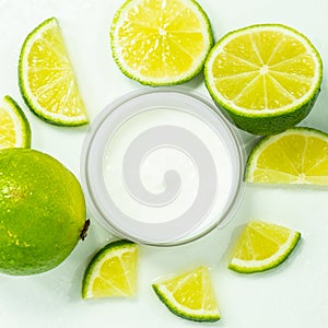 Cosmetic cream for skin care in a jar with lime. Moisturizing cream. close-up of body lotion, cream and lime on the table.