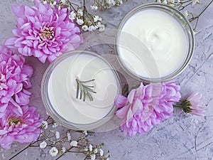 Cosmetic cream, wellness product moisturizing natural lotion flower on on a concrete background
